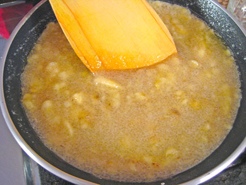Cooking of mashed banana and sugar with butter