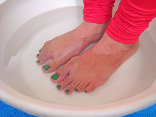 Immersing feet in warm water
