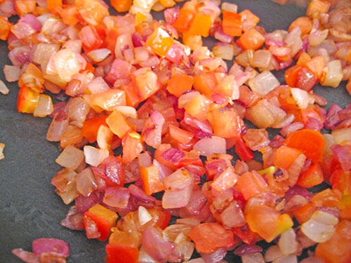 Adding tomato and cooking with onion