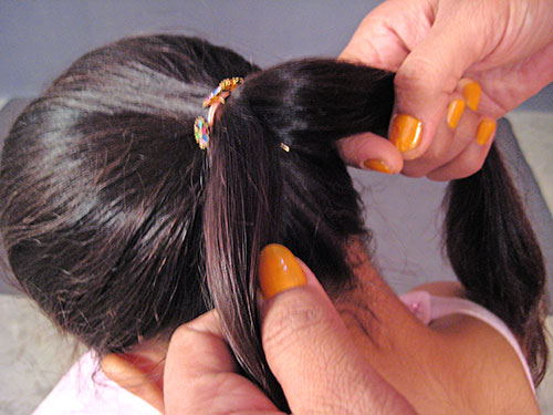 Divide ponytail in 2 equal parts