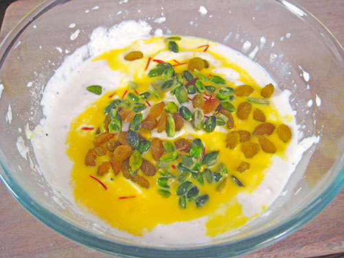 Adding of saffron and dry fruits