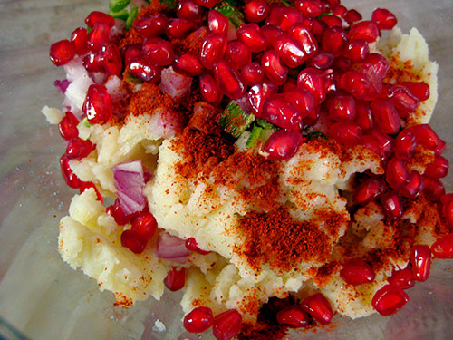 Adding of all the spices and pomegranate seeds